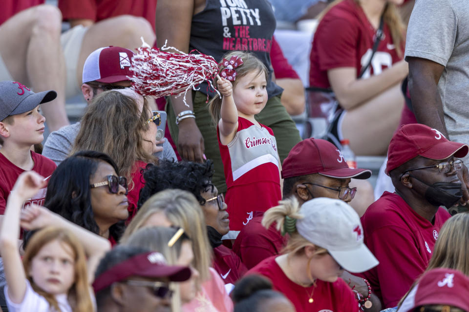 A young Alabama fan cheers during the team's A-Day NCAA college football scrimmage Saturday, April 13, 2024, in Tuscaloosa, Ala. (AP Photo/Vasha Hunt)
