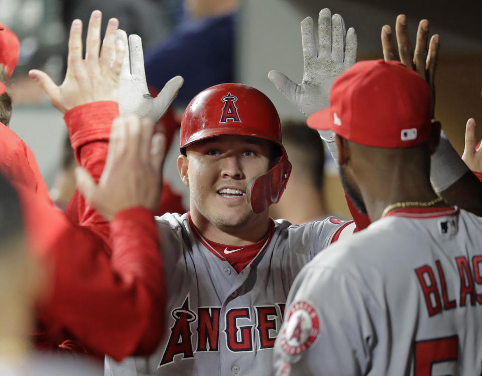 Los Angeles Angels’ Mike Trout is greeted in the dugout after he hit a two-run home run during the seventh inning against the Seattle Mariners in a baseball game Tuesday, June 12, 2018, in Seattle. It was Trout’s second home run of the game. (AP Photo/Ted S. Warren)