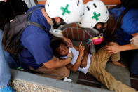 Volunteers members of primary care response team help a child during a rally against President Nicolas Maduro in Caracas, Venezuela May 24, 2017. REUTERS/Carlos Garcia Rawlins