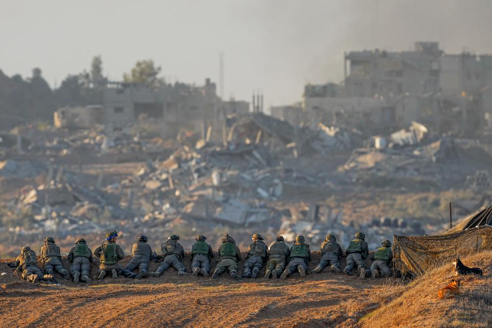 Israeli soldiers take positions near the Gaza Strip border, in southern Israel, Monday, Dec. 11, 2023. The army is battling Palestinian militants across Gaza in the war ignited by Hamas' Oct. 7 attack into Israel.