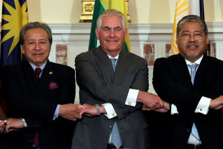 U.S. Secretary of State Rex Tillerson (C) poses with Malaysia's Foreign Minister Datuk Seri Anifah Aman (L) and Philippines' acting Foreign Minister Enrique Manalo (R) before a working lunch for the foreign ministers of ASEAN member states at the State Department in Washington, U.S., May 4, 2017. REUTERS/Yuri Gripas