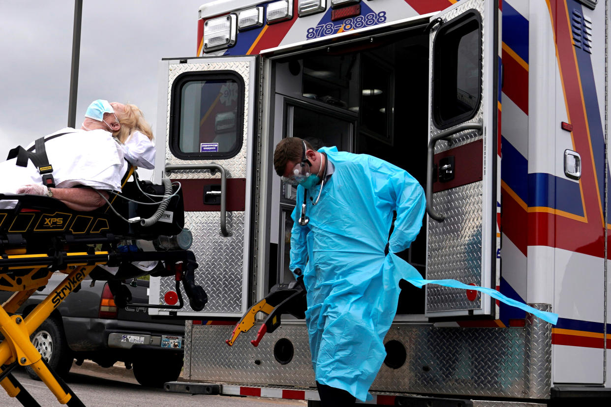 REACT EMS paramedics wearing protective gear load a potential coronavirus disease (COVID-19) patient for transport in Shawnee, Oklahoma, U.S. April 2, 2020. REUTERS/Nick Oxford     TPX IMAGES OF THE DAY