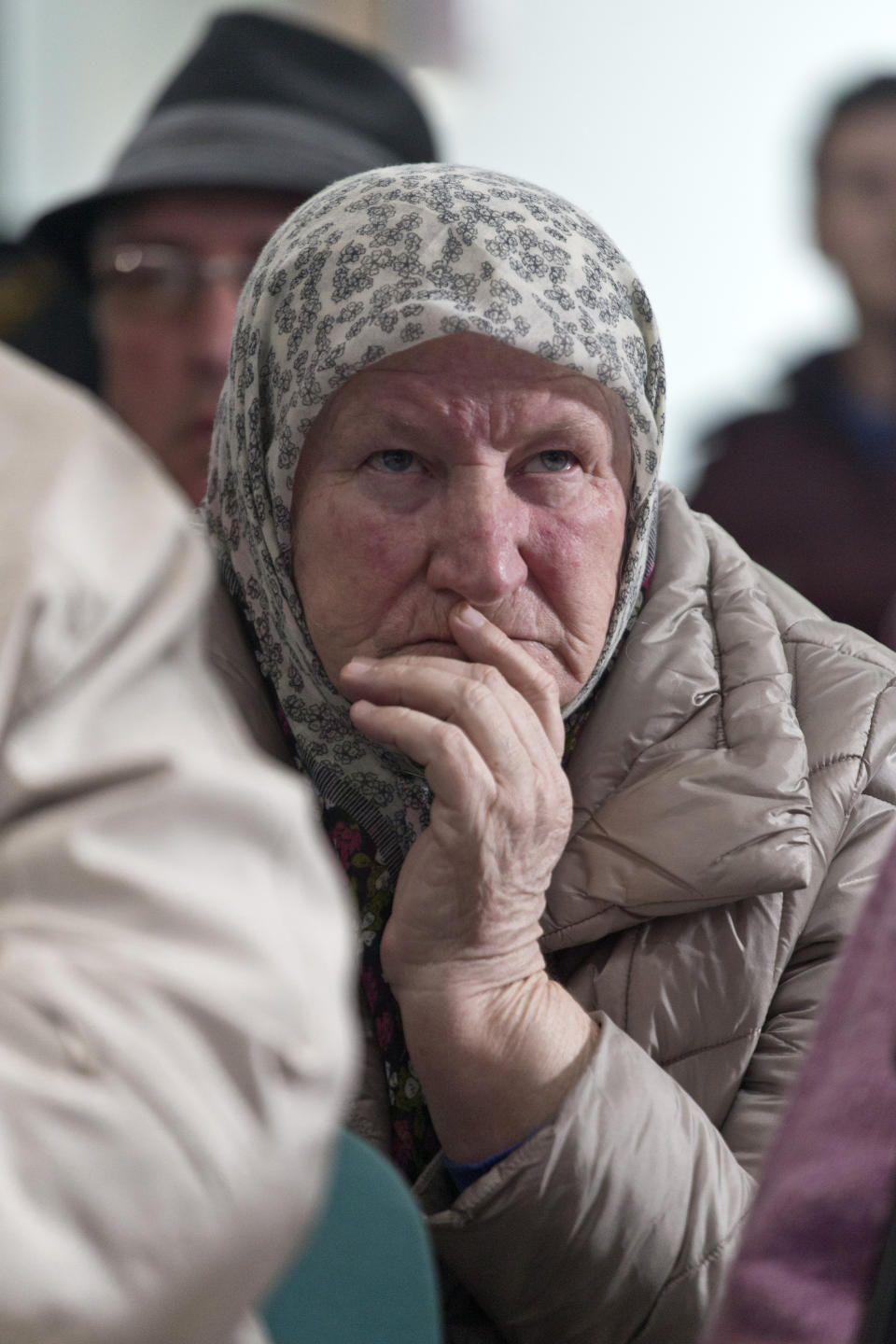 A relative of victims of the Srebrenica genocide awaits the decision of the UN appeals judges on former Bosnian Serb leader Radovan Karadzic in Potocari, Bosnia and Herzegovina, Wednesday, March 20, 2019. United Nations appeals judges on Wednesday upheld the convictions of Karadzic for genocide, war crimes and crimes against humanity, and increased his sentence from 40 years to life imprisonment. (AP Photo/Marko Drobnjakovic)