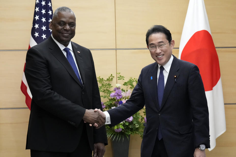 U.S. Defense Secretary Lloyd Austin, left, and Japanese Prime Minister Fumio Kishida shake hands prior to their meeting at the prime minister's office in Tokyo Thursday, June 1, 2023. (AP Photo/Eugene Hoshiko, Pool)