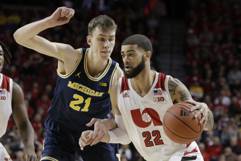 Nebraska's Haanif Cheatham (22) drives around Michigan's Jace Piatkowski (21), during the first half of an NCAA college basketball game in Lincoln, Neb., Tuesday, Jan. 28, 2020. (AP Photo/Nati Harnik)