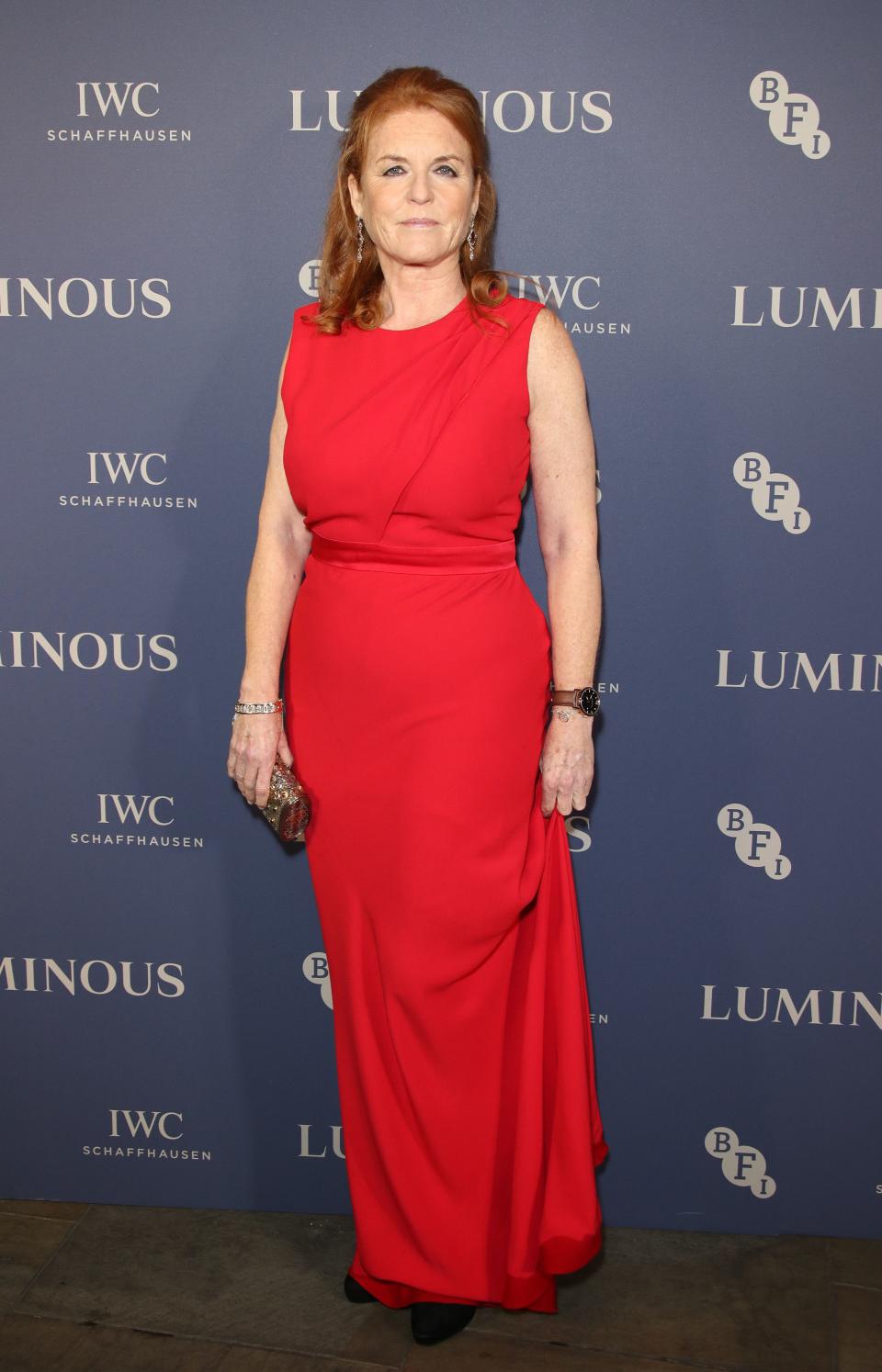 Sarah Ferguson is seen in a red colored long dress with black pumps to match.