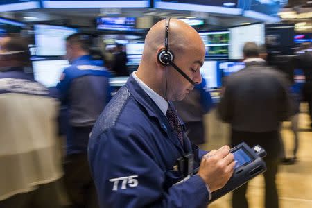 Traders work on the floor of the New York Stock Exchange, June 30, 2015. REUTERS/Lucas Jackson