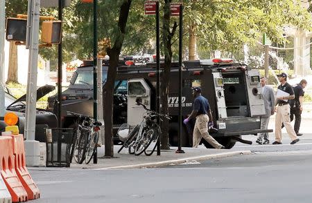 Police investigate the scene near an SUV in which a man suspected of causing a bomb scare barricaded himself, causing an hours-long standoff and the shutdown of a mid-Manhattan area in New York City, New York, U.S. July 21, 2016. REUTERS/Brendan McDermid