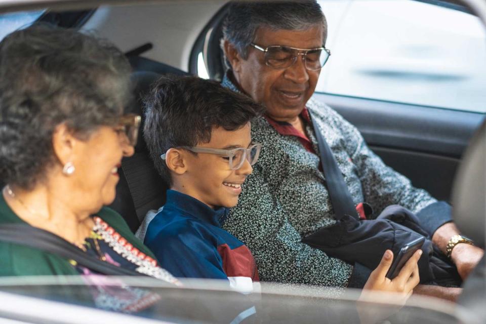 Multi-generation family enjoying car ride