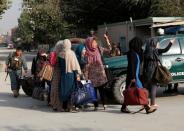 Students walk toward a police vehicle after they were rescued from the site of an attack at the American University of Afghanistan in Kabul, Afghanistan August 25, 2016. REUTERS/Mohammad Ismail