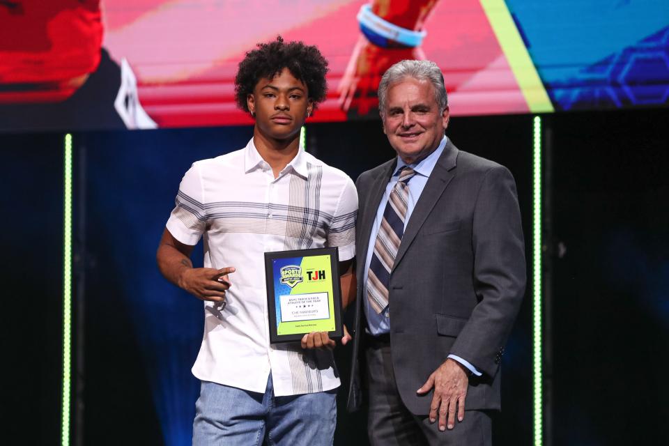Che Nwabuko of Manor High was named boy Athlete of the Year at the American-Statesman's Central Texas sports ceremony Monday at the Long Center. He poses here with sports writer Rick Cantu.