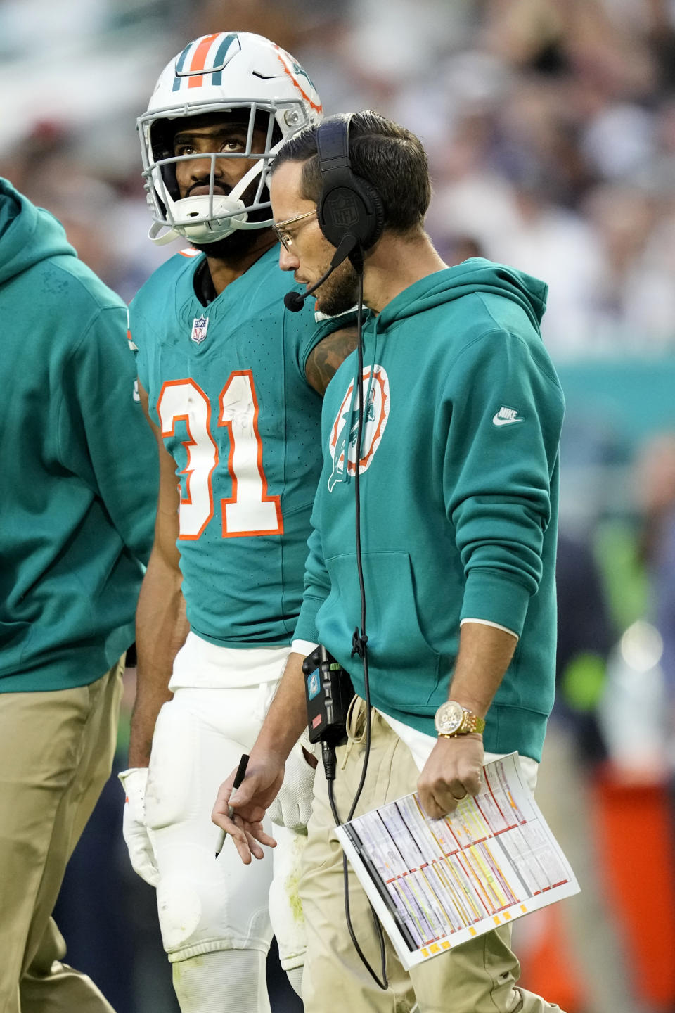 Miami Dolphins head coach Mike McDaniel, right, stands with running back Raheem Mostert (31) during the first half of an NFL football game against the Dallas Cowboys, Sunday, Dec. 24, 2023, in Miami Gardens, Fla. (AP Photo/Rebecca Blackwell)