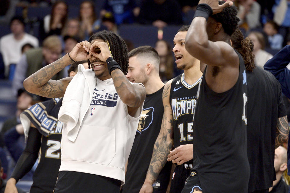 Memphis Grizzlies guard Ja Morant, far left, forward Brandon Clarke (15) and teammates react in the second half of an NBA basketball game against the New Orleans Pelicans Friday, Nov. 25, 2022, in Memphis, Tenn. (AP Photo/Brandon Dill)