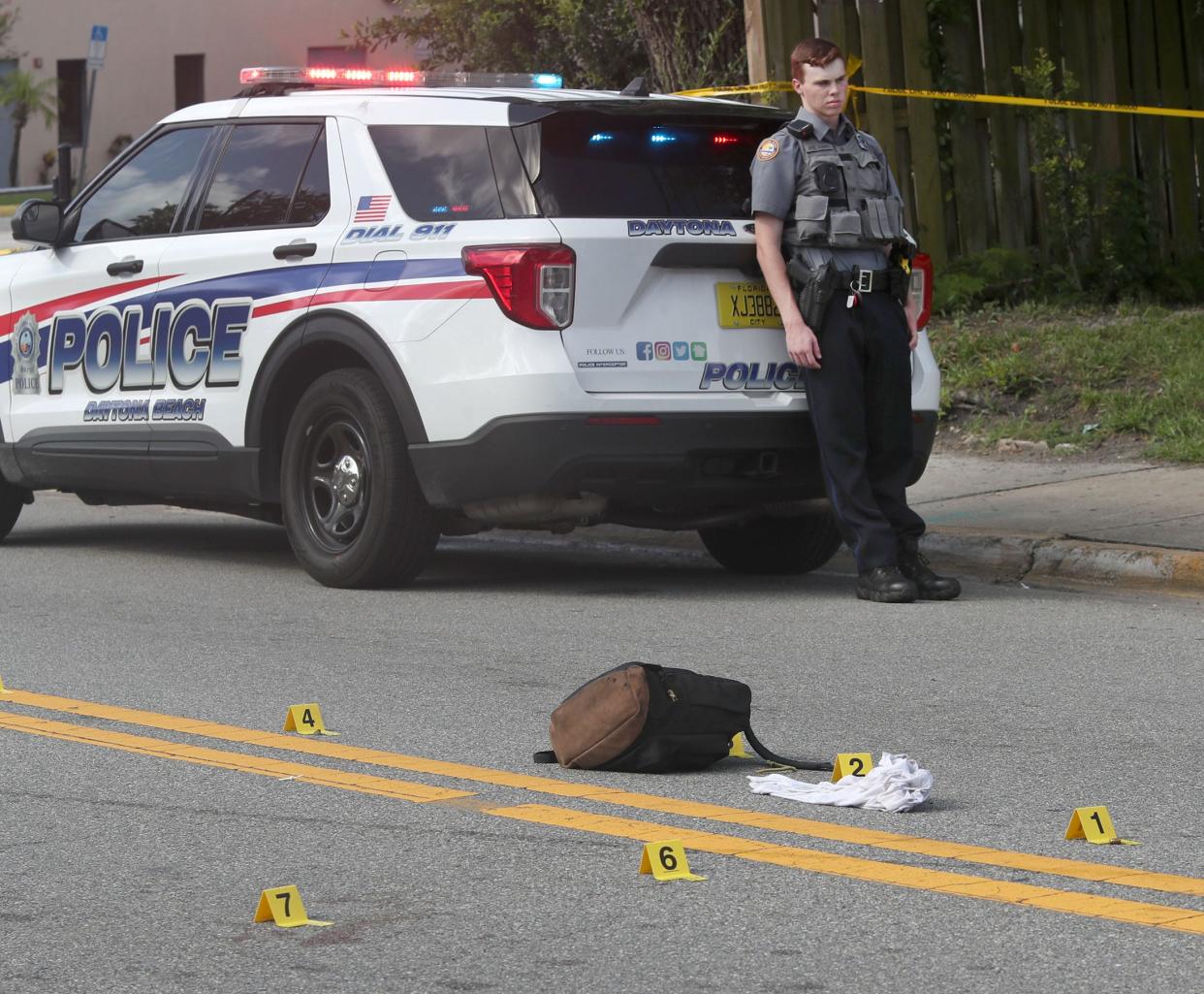 Evidence markers were set up on Dr. Martin Luther King Boulevard as Daytona Beach police investigators and a medical examiner work the scene of a fatal shooting of three people, Wednesday July 12, 2023.