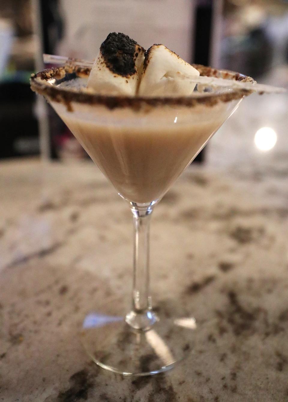The S'mores Martini, made with Godiva chocolate liqueur, marshmallow vodka, heavy cream, Hershey's chocolate syrup and topped with toasted marshmallows, is one of the Halloween-themed cocktails at The Daily Pressed, which has created a Halloween pop-up bar.