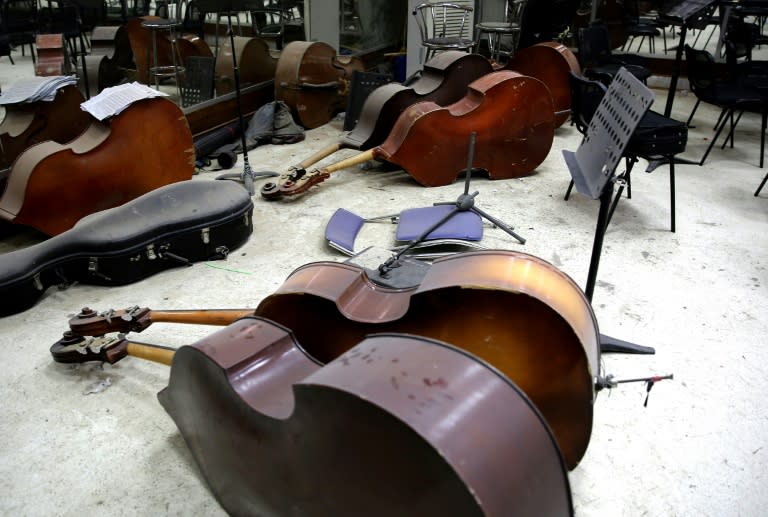 The orchestra rehearses in a dusty dance studio, with intermittent power outages cutting out the lights and an ageing air conditioner