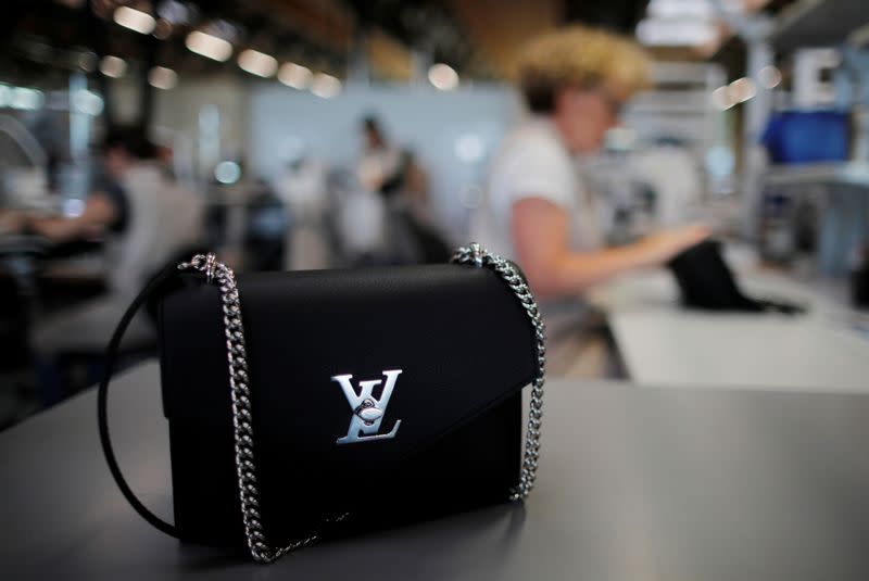 FILE PHOTO: The logo of Louis Vuitton is seen on a handbag as an employee works in a Vuitton new high-end garment factory in Beaulieu-sur-Layon