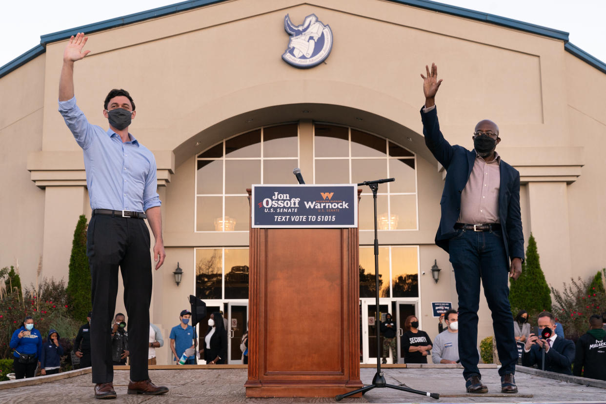 Democratic U.S. Senate candidates Raphael Warnock and Jon Ossoff are seen at a campaign event on November 19, 2020 in Jonesboro, Georgia. (Photo by Elijah Nouvelage/Getty Images)