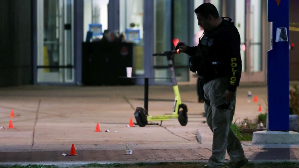 PHOTO: A police officer searches for evidence in front of a building at Morgan State University after a shooting, Oct. 4, 2023, in Baltimore. (Julia Nikhinson/AP)