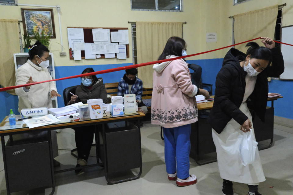 Shimray Wungreichon, 43, left, speaks with a doctor at the District Hospital in Ukhrul, in the northeastern Indian state of Manipur, Friday, Jan. 15, 2021. “This kind of collective fear has never been seen before. Nobody wants to die,” Wungreichon said talking about the COVID-19 pandemic, while working in the emergency department at the district hospital in Ukhrul, the only government-run medical facility that caters to a population of 180,000. “People have realized that their lives are precious.” (AP Photo/Yirmiyan Arthur)