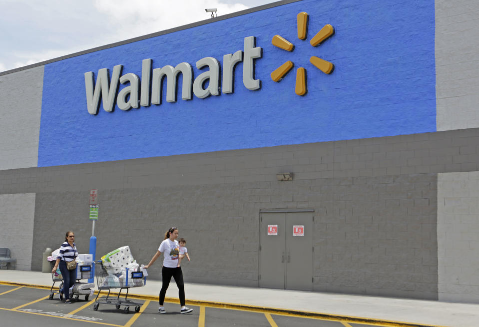 Customers walk out of a Walmart store in Florida 