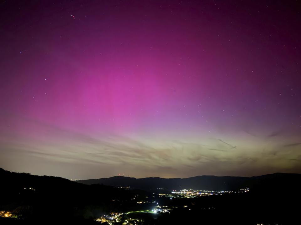 Northern lights appear over the Dreisamtal valley in the Black Forest near Freiburg, Germany, Friday evening, May 10, 2024. (Valentin Gensch/dpa via AP)