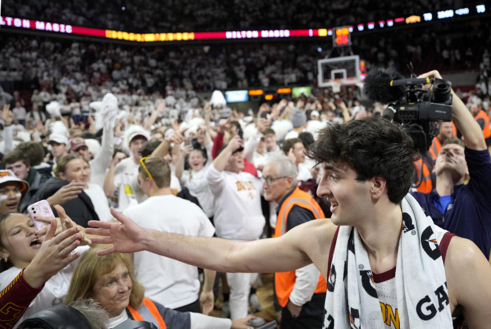 Iowa State forward Milan Momcilovic (22) celebrates a 79-75 win over Kansas as fans storm the court after a NCAA college basketball game, Saturday, Jan. 27, 2024, in Ames, Iowa. (AP Photo/Matthew Putney)