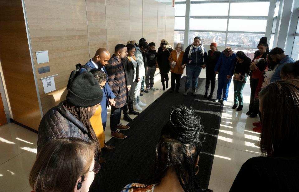 Supporters of Casey Goodson Jr. pray for justice in a hallway at the Franklin County Courthouse near the courtroom where former Franklin County Sheriff's deputy Jason Meade is on trial for murder for fatally shooting the 23-year-old Goodson on Dec. 4, 2020 at his grandmother's house in North Linden.