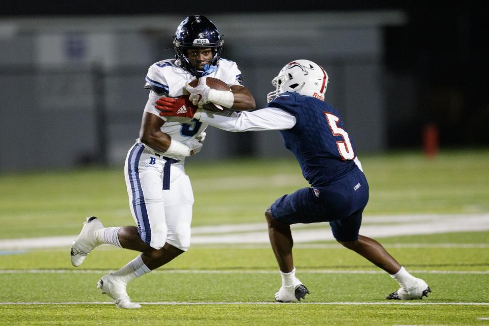 Berkeley Prep's Xavier Townsend (3) tries to dodge a tackle from Chaminade-Madonna's D'angelo Ponds (5). Chaminade-Madonna leads Berkeley Prep 7-0 at the half of the 3A State Championship game at Gene Cox Stadium on Friday, Dec. 10, 2021.