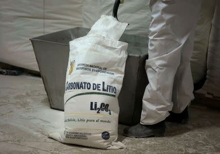 A worker loads lithium carbonate at the pilot plant of Llipi on the shores of the salt flats of Uyuni, Potosi department, Bolivia, November 29, 2017. REUTERS/David Mercado