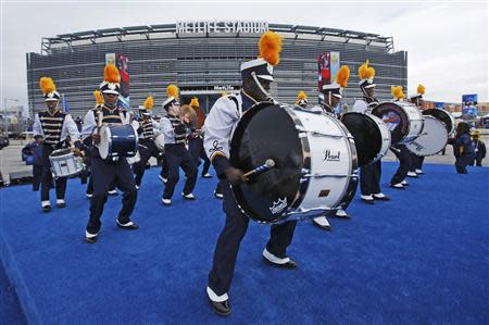 A marching band performs outside the stadium before the start the NFL Super Bowl XLVIII football game in East Rutherford, New Jersey, February 2, 2014. REUTERS/Eduardo Munoz