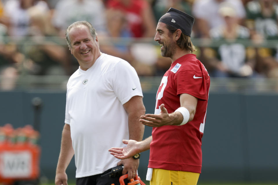 CORRECTS MONTH TO JULY, NOT AUG. - Green Bay Packers' quarterback Aaron Rodgers has a laugh with assistant athletic trainer Kurt Fielding during NFL football training camp Wednesday, July 28, 2021, in Green Bay, Wis. (AP Photo/Matt Ludtke)