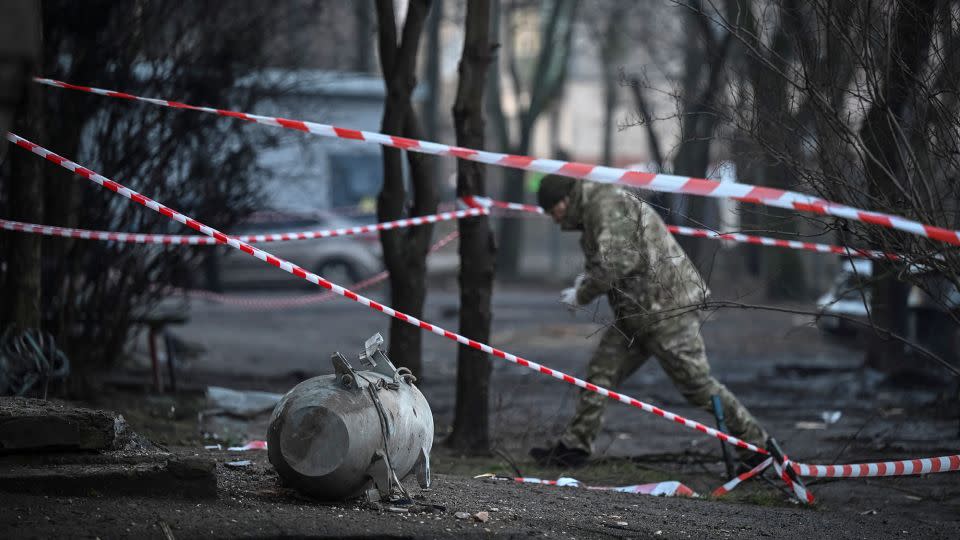A bomb squad member works next to a part of a missile. - Viacheslav Ratynskyi/Reuters