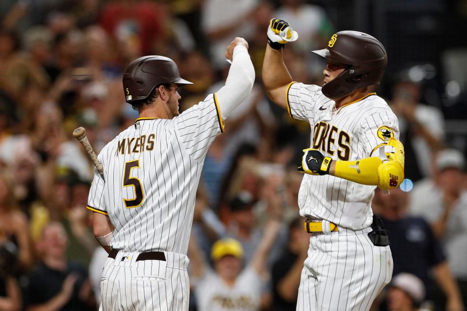 San Diego Padres' Ha-Seong Kim celebrates with Wil Myers after hitting a solo home run against the Arizona Diamondbacks in the fifth inning of a baseball game Tuesday, Sept. 6, 2022, in San Diego. (AP Photo/Brandon Sloter)