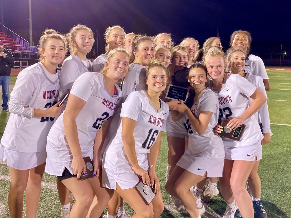 The Morristown girls lacrosse team celebrates after defeating Chatham to defend its Morris County Tournament title on May 11, 2024.