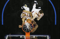 Philadelphia 76ers' Joel Embiid, center, goes up for a rebound against Cleveland Cavaliers' Jarrett Allen, left, and Dean Wade during the first half of an NBA basketball game, Saturday, Feb. 27, 2021, in Philadelphia. (AP Photo/Matt Slocum)