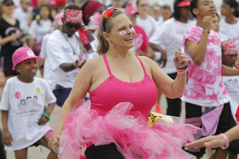 CORRECTS TO REMOVE REFERENCE TO NUMBER OF YEARS AND RACES, TIGHTEN 2ND HALF OF CAPTION - In this April 14, 2012, photo Teresa Blackington of Alvaredo warms up before the Susan G. Komen Race for the Cure in Fort Worth, Texas. Organizers of Race for the Cure events across the country have reported drops in participation following a controversy involving Planned Parenthood. In Fort Worth, participation declined by 23 percent. (AP Photo/Star-Telegram, Joyce Marshall) MAGS OUT