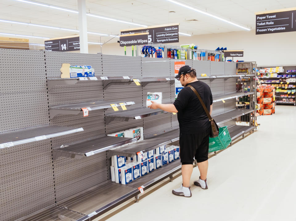  man looks for toilet paper in an Australian supermarket after panic buying due to the Corona Virus