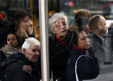 Commuters wait to board buses during London Underground strikes at Kings Cross underground station in London February 6, 2014. REUTERS/Olivia Harris