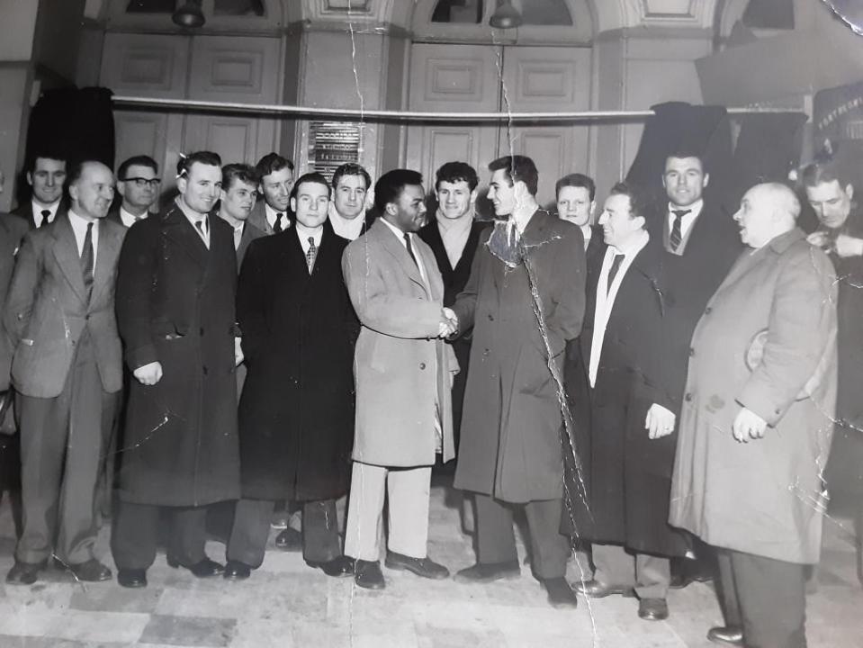 Eastern Daily Press: Boxers, fans and officials  gather to mark the occasion when Tony Webster (centre right) shakes