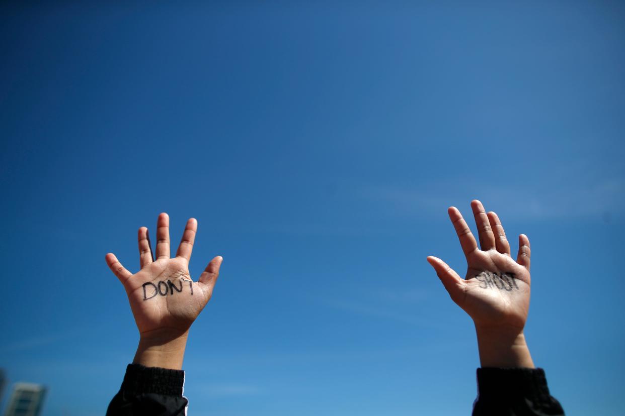 A student holds up her hands while taking part in National School Walkout Day to protest school violence on April 20, 2018 in Chicago, Illinois. Students from around the nation joined in the walkout against gun violence on the 19th anniversary of the Columbine shooting.