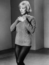 <p>The bombshell's light purple cable knit and black tights look <a href="https://www.youtube.com/watch?v=i5cGCzS-6C0" rel="nofollow noopener" target="_blank" data-ylk="slk:while singing the song;elm:context_link;itc:0;sec:content-canvas" class="link ">while singing the song</a> "My Heart Belongs to Daddy" continues to be one of her most memorable ever.</p>