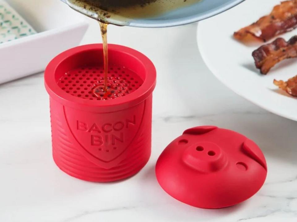 It comes with a built-in strainer to catch leftover bacon bits &mdash; you can pop it in the freezer and use it for future cooking endeavors. This reusable, silicone design is safe up to 500 degrees Fahrenheit, resists stains and odors, and holds one cup of cooled grease.<br /><br /><strong>Promising review:</strong> "After using just about anything that wouldn't melt, this is the best bacon grease container ever. Easy to use, easy to clean...love the piggy!" &mdash; <a href="https://www.thegrommet.com/products/talisman-designs-bacon-bin-silicone-grease-container" target="_blank" rel="noopener noreferrer">Michael</a><br /><br /><strong>Get it from The Grommet for <a href="https://go.skimresources.com?id=38395X987171&amp;xs=1&amp;url=https%3A%2F%2Fwww.thegrommet.com%2Fproducts%2Ftalisman-designs-bacon-bin-silicone-grease-container&amp;xcust=HPWantedKitchenGadgets6087326be4b09a22a4461b8c" target="_blank" rel="noopener noreferrer">$15</a>.</strong>