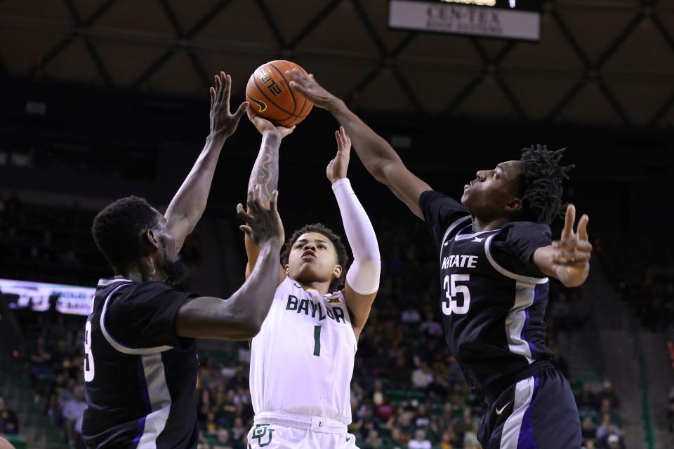 Baylor guard Keyonte George (1) shoots between Kansas State center Abayomi Iyiola, left, and forward Nae'Qwan Tomlin (35) in the first half of an NCAA college basketball game, Saturday, Jan. 7, 2023, in Waco, Texas. (AP Photo/Rod Aydelotte)