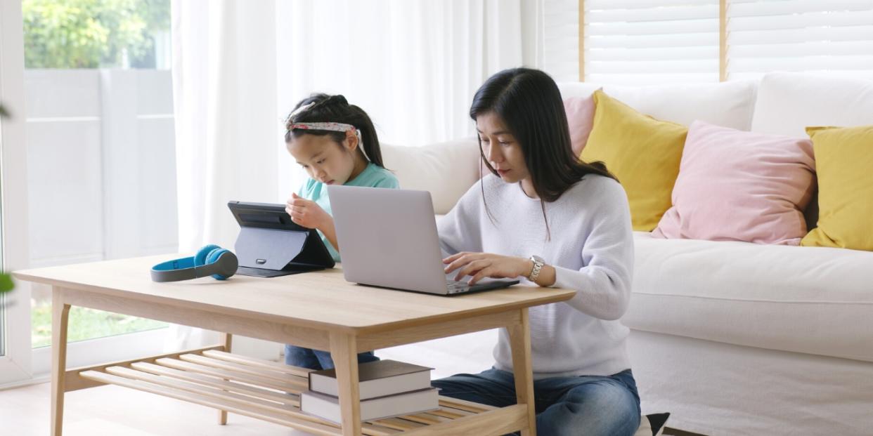 asian mother and child working on computers tech talk