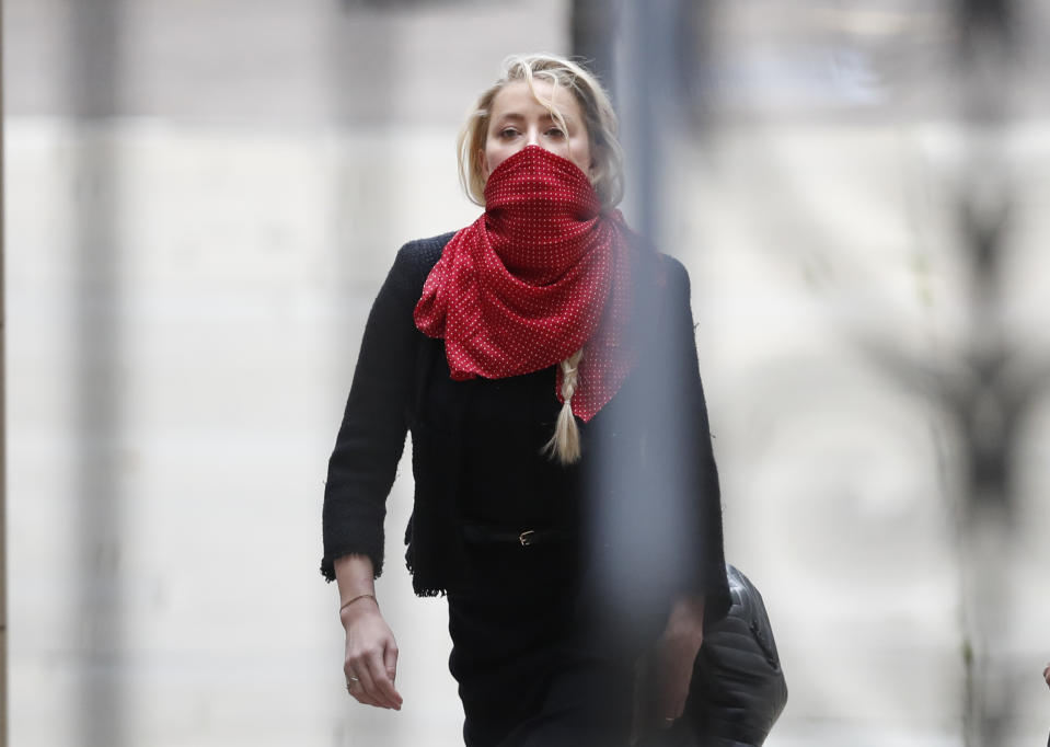 Actress Amber Heard, center, arrives at the High Court in London, Monday, July 13, 2020. Johnny Depp is expected to wrap up his evidence at his libel trial against a tabloid newspaper that accused him of abusing ex-wife Amber Heard. The Hollywood star is suing News Group Newspapers, publisher of The Sun, and the paper’s executive editor, Dan Wootton, over an April 2018 article that called him a “wife-beater. (AP Photo/Alastair Grant)