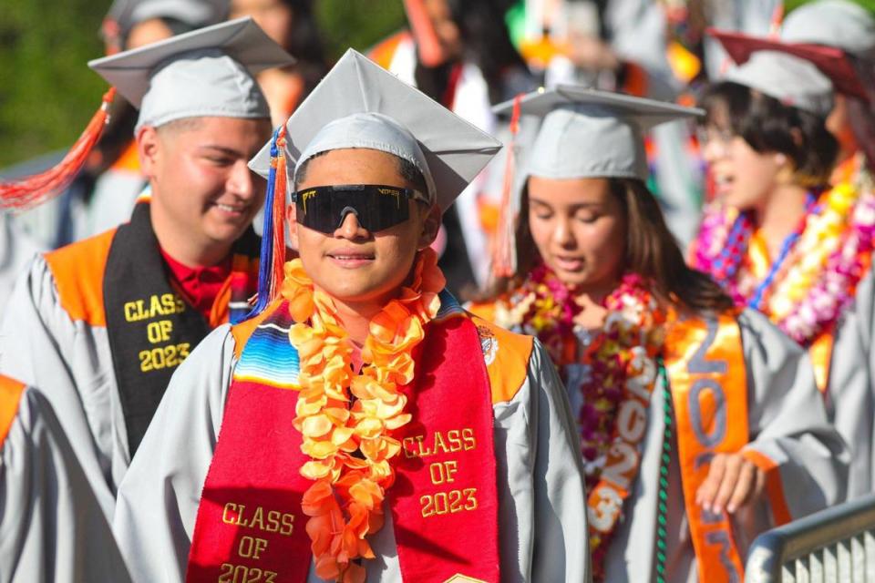 Jesus Estrada in red sash walks to the stadium. Atascadero held their 102nd commencement ceremony for the Class of 2023.