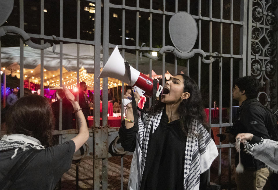 Pro-Palestinian protesters gather outside the gates to the courtyard at the University of Pennsylvania Museum on Friday, May 17, 2024 in Philadelphia. Authorities say a half-dozen University of Pennsylvania students were among 19 pro-Palestinian protesters arrested during an attempt to occupy a building on campus. University police say seven remained in custody Saturday awaiting felony charges from Friday's incident, including one person who allegedly assaulted an officer. (Charles Fox/The Philadelphia Inquirer via AP)