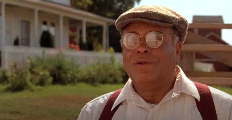 A man speaks on a baseball field