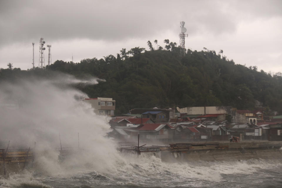 Strong waves batter houses along the coastline of Catbalogan city, Western Samar province, eastern Philippines, caused by typhoon Vongfong Thursday, May, 14, 2020. A strong typhoon slammed into the eastern Philippines on Thursday after authorities evacuated tens of thousands of people while trying to avoid the virus risks of overcrowding emergency shelters. (AP Photo/Simvale Sayat)